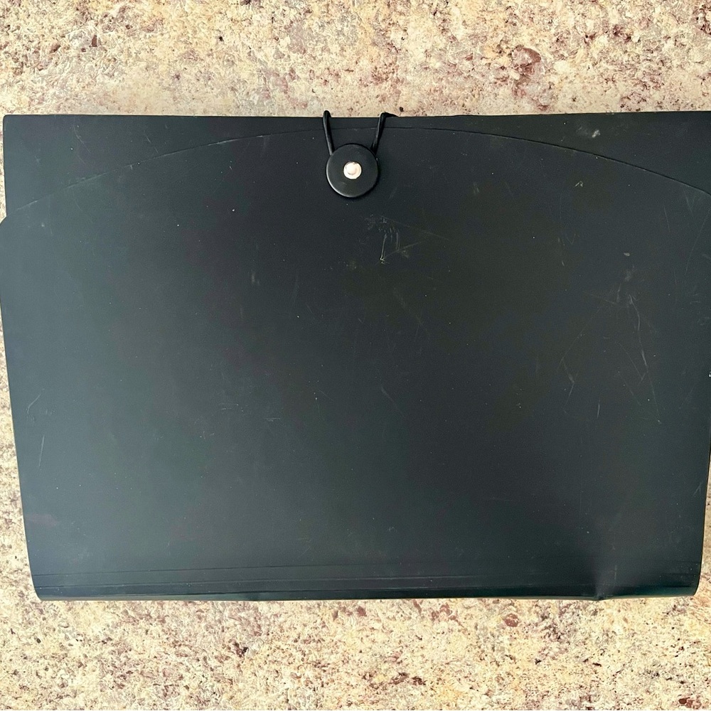 Expanding file folder with flap and cord closure for organizing and securing
